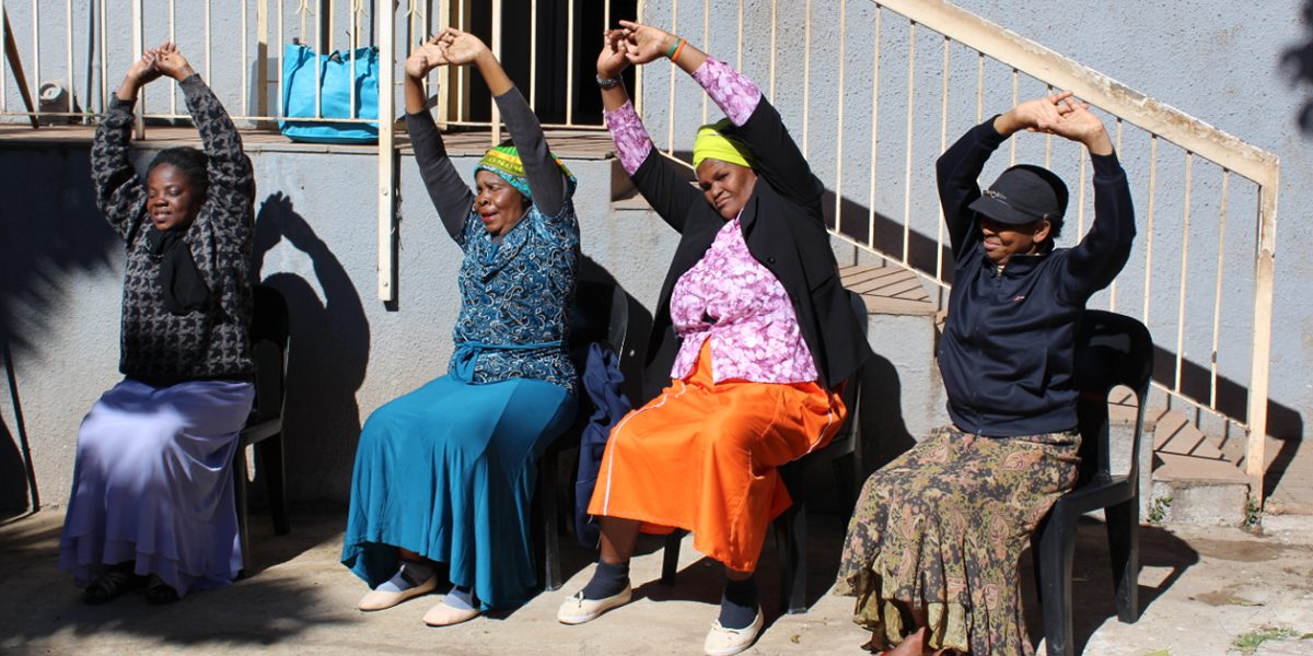 Women enrolled in the JRS South Africa Elderly Program practice yoga.